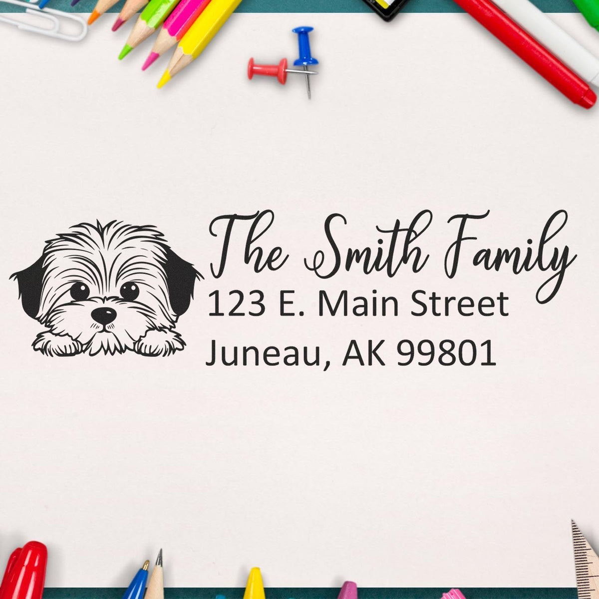 Custom return address rubber stamp with dog illustration, The Smith Family name, and Juneau, AK address.