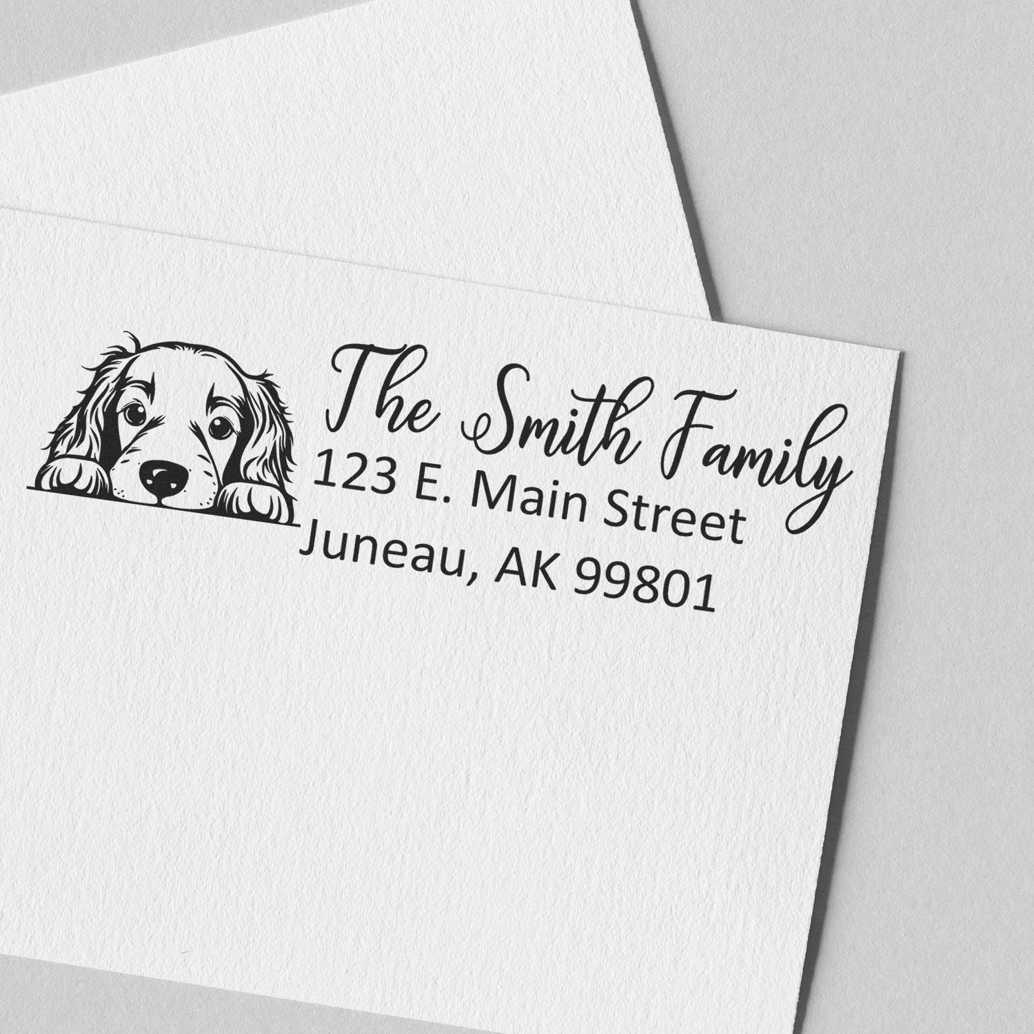 Custom return address rubber stamp with dog illustration for The Smith Family, Juneau, AK 99801.