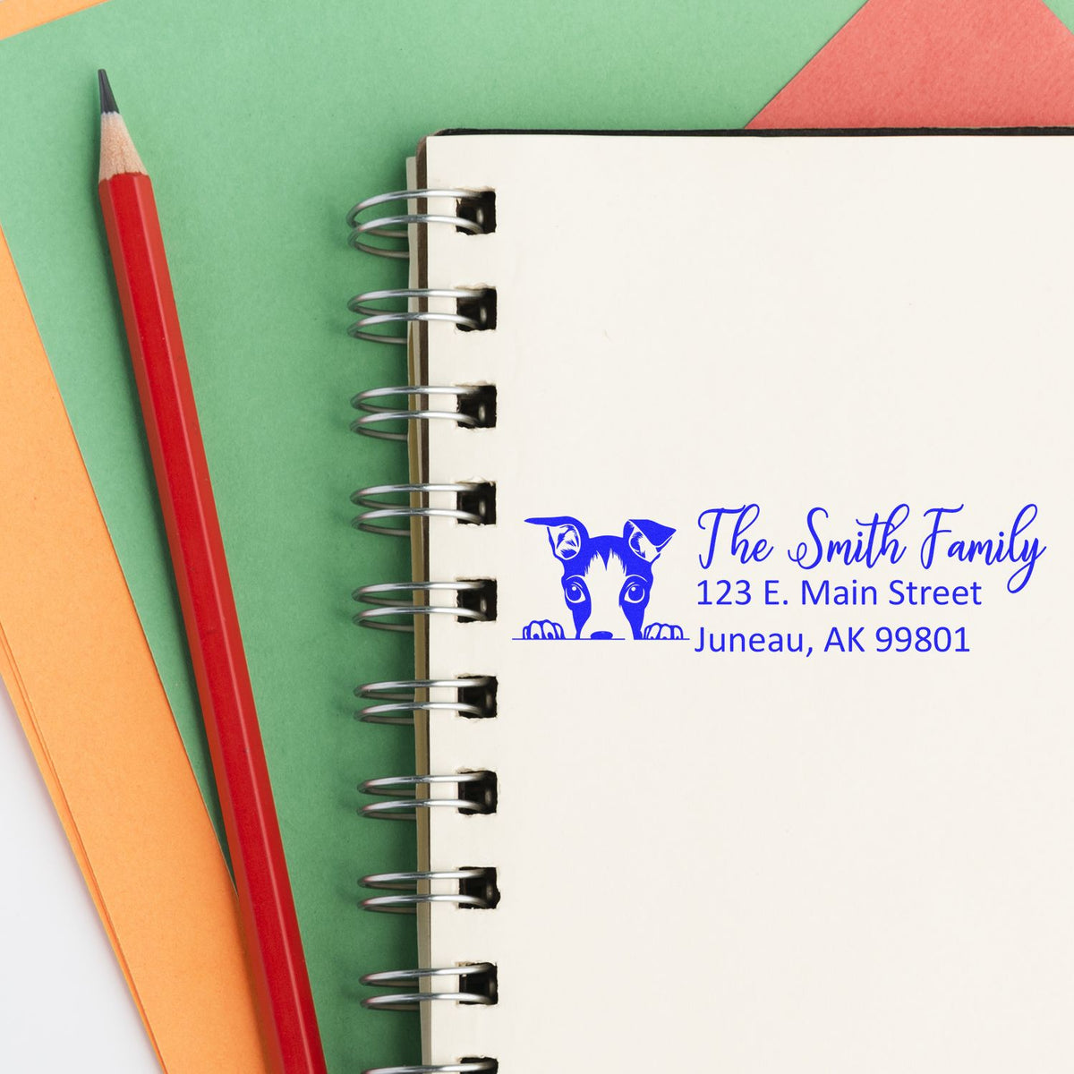 Personalized return address rubber stamp with dog logo for The Smith Family, Juneau, AK, for mailing and branding.