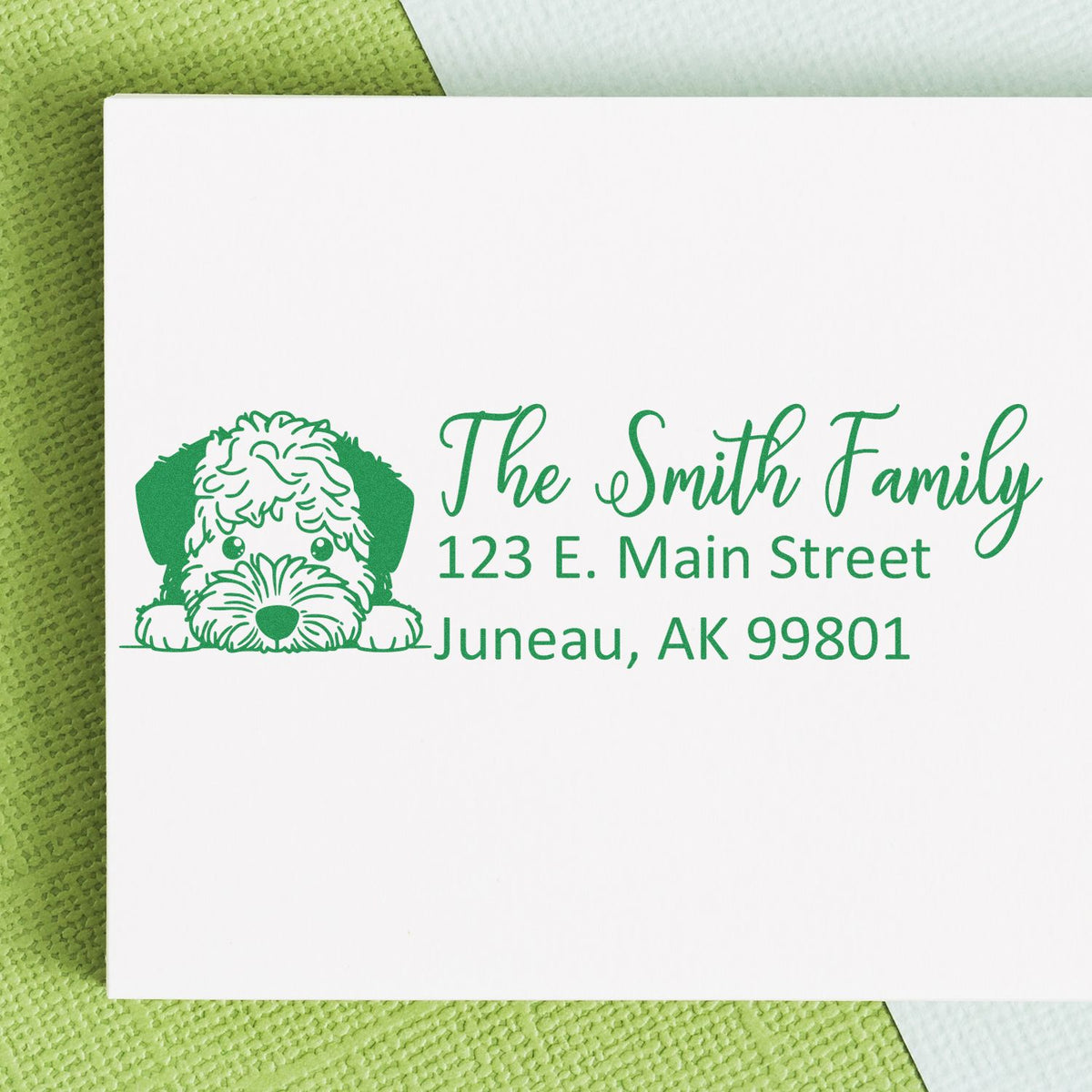 Personalized address rubber stamp with dog illustration, Smith Family name, and Juneau, AK for envelopes and packaging.