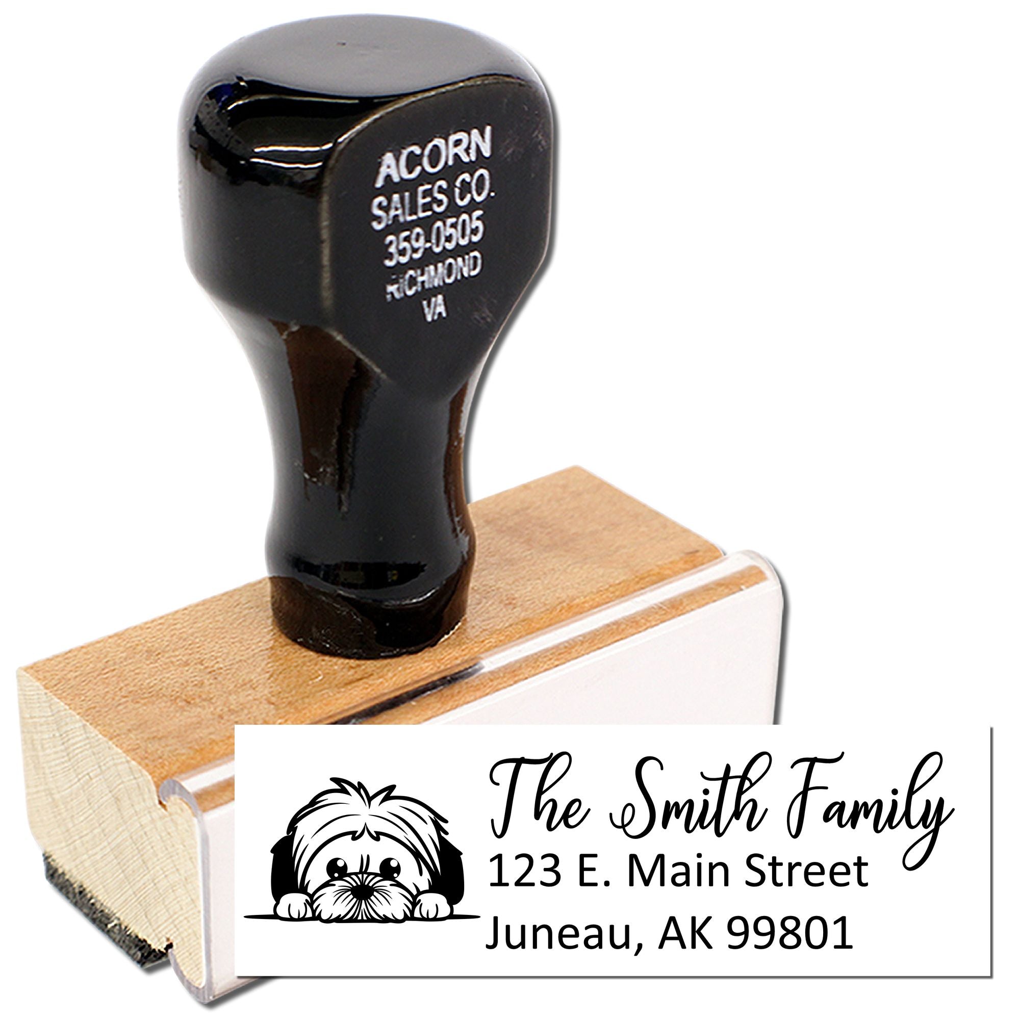 Custom address rubber stamp with dog illustration, family name, and mailing details on a wood-mounted stamp handle.