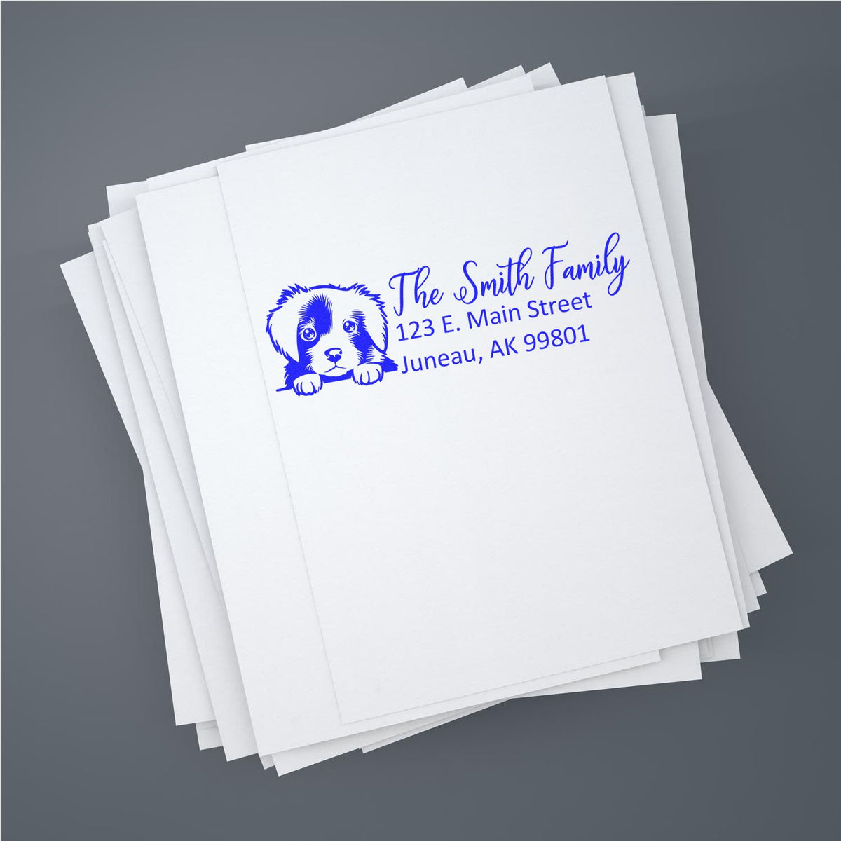 Custom family rubber return address stamp with dog icon for personalized mailing envelopes.