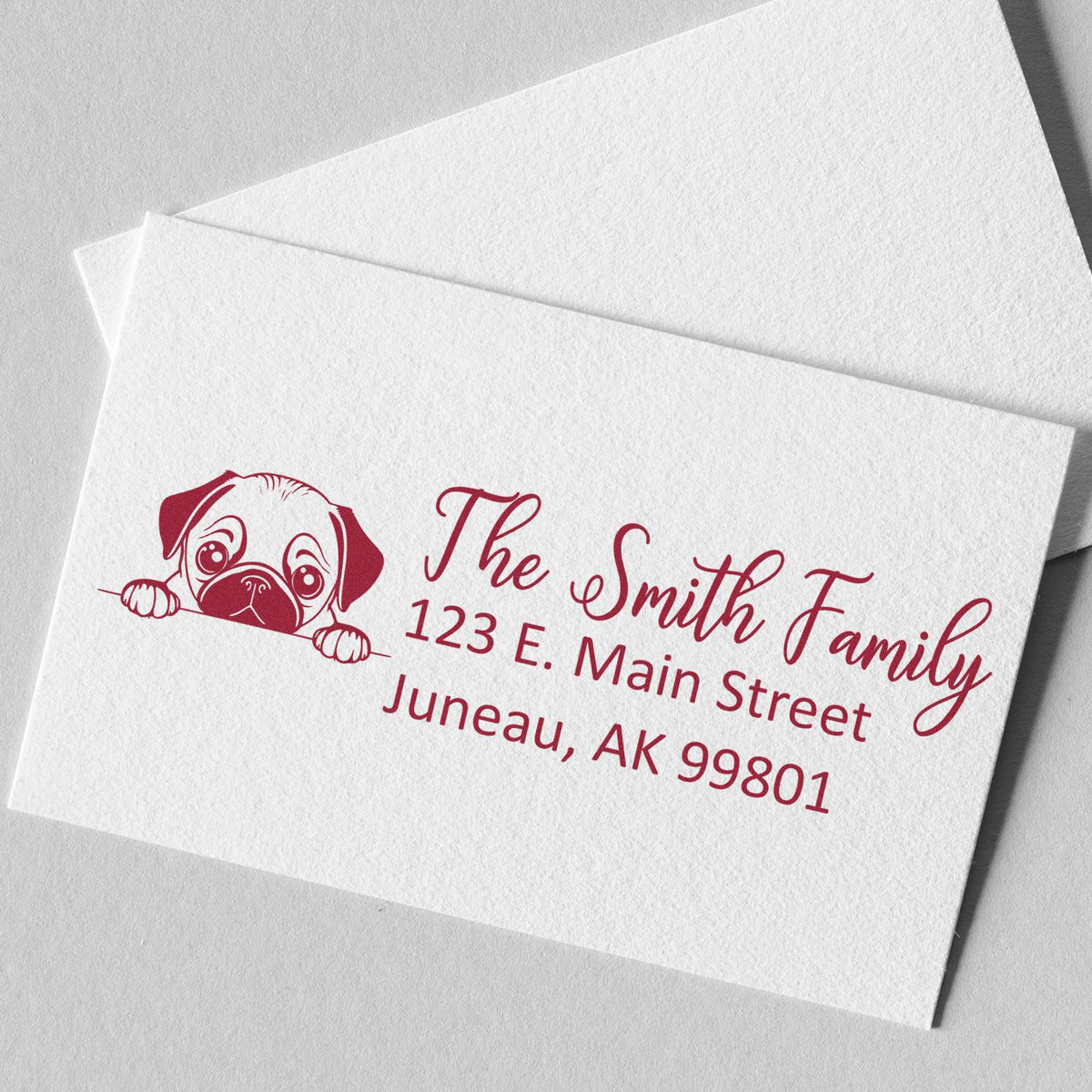 Personalized return address rubber stamp with pug design for The Smith Family, 123 E. Main Street, Juneau, AK 99801.