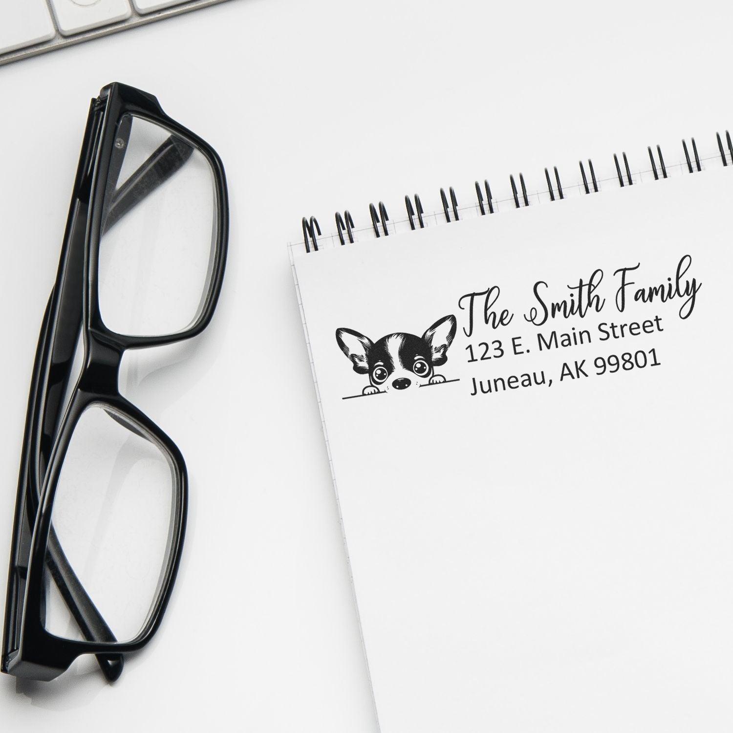 Personalized return address rubber stamp with family name and dog design for stationery, envelopes, and mailing labels.