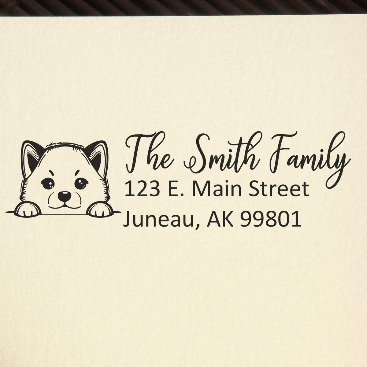 Personalized rubber return address stamp with dog design for The Smith Family, Juneau, AK 99801.