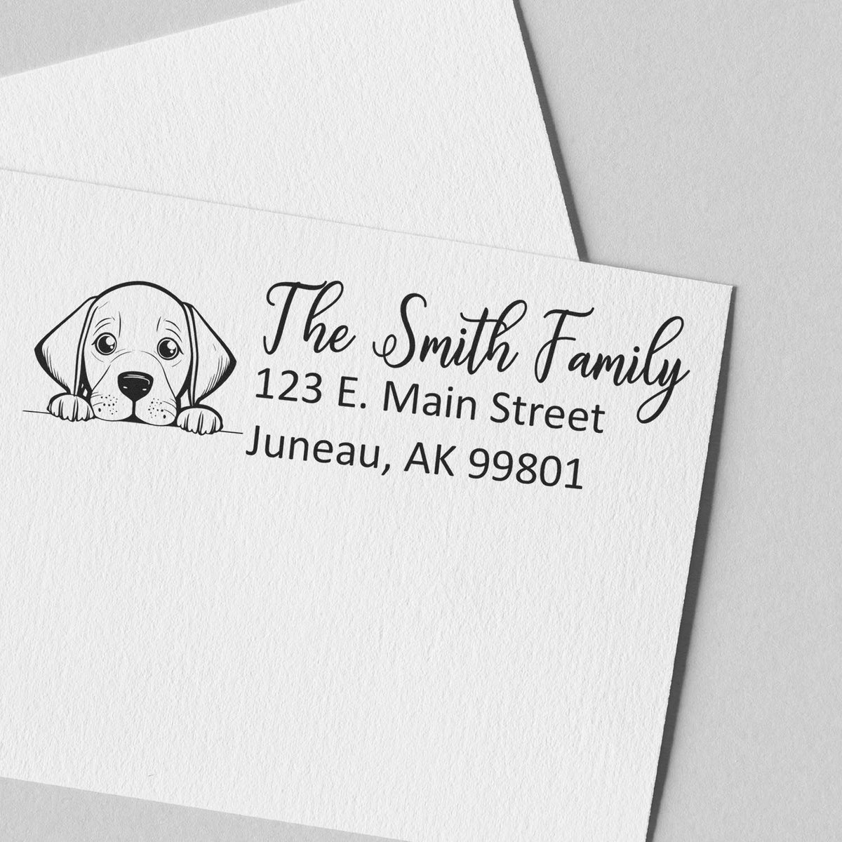 Custom rubber address stamp with puppy illustration for The Smith Family, 123 E. Main Street, Juneau, AK 99801.