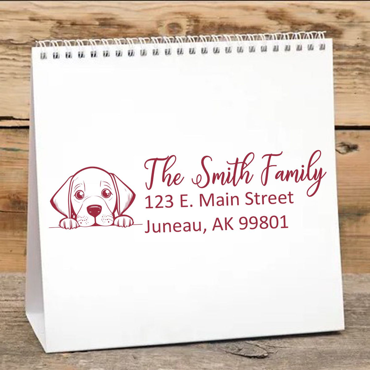 Custom dog return address rubber stamp with family name and Juneau, AK address on a gift bag.