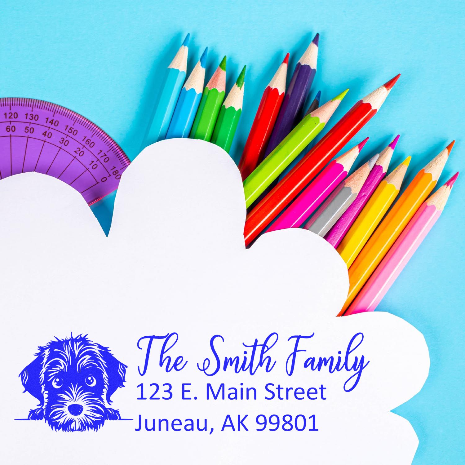 Personalized dog address rubber stamp for The Smith Family, featuring Juneau, AK return address on a colorful school supplies background.