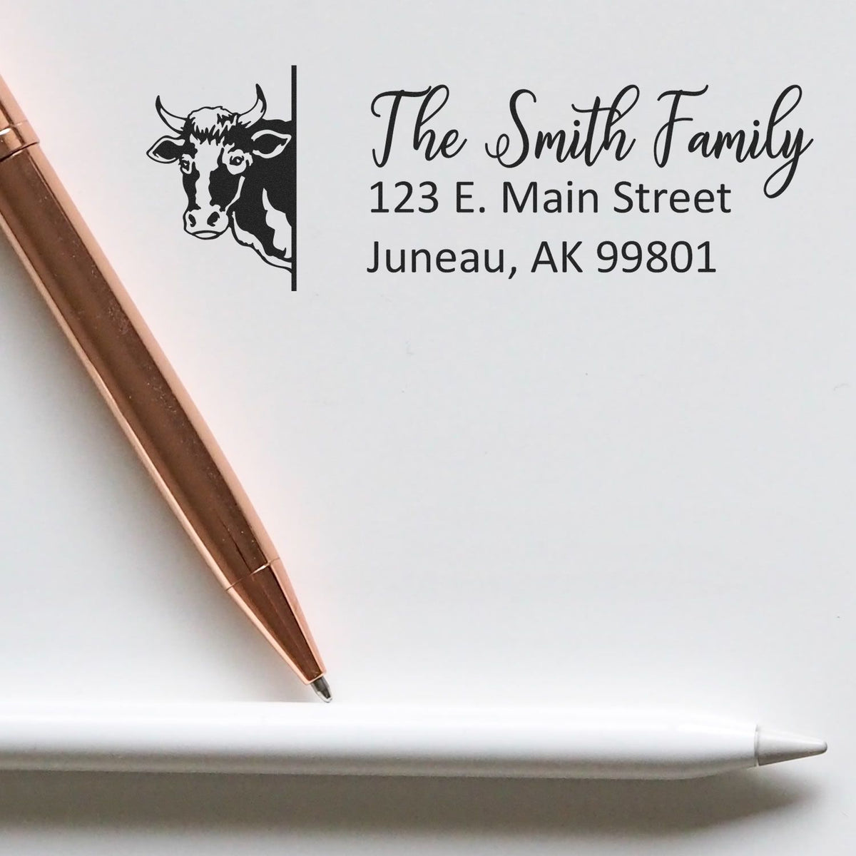 Personalized rubber address stamp with cow logo, The Smith Family, and Juneau, AK return address.