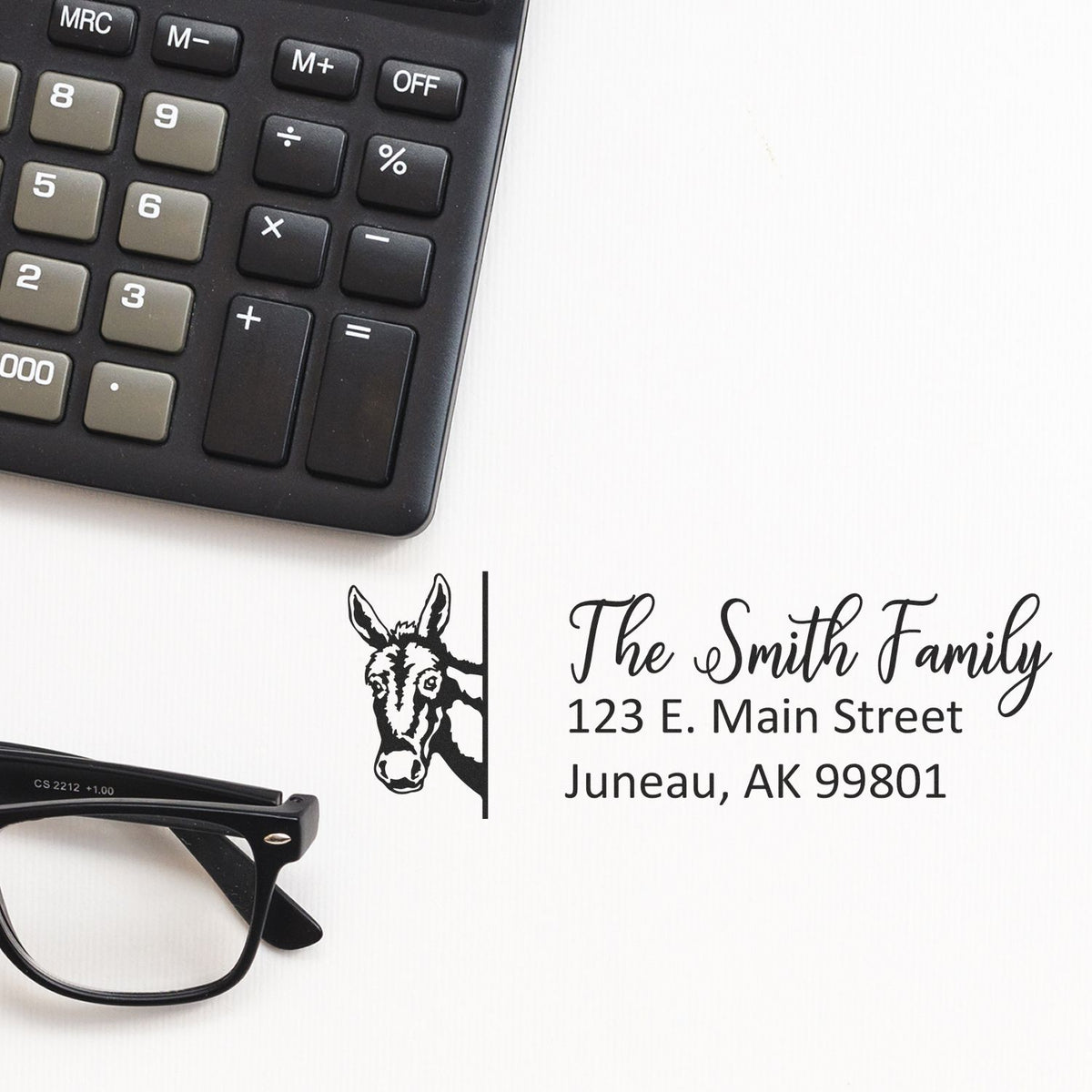 Custom return address rubber stamp with donkey design, showing The Smith Family name and Juneau, AK address.
