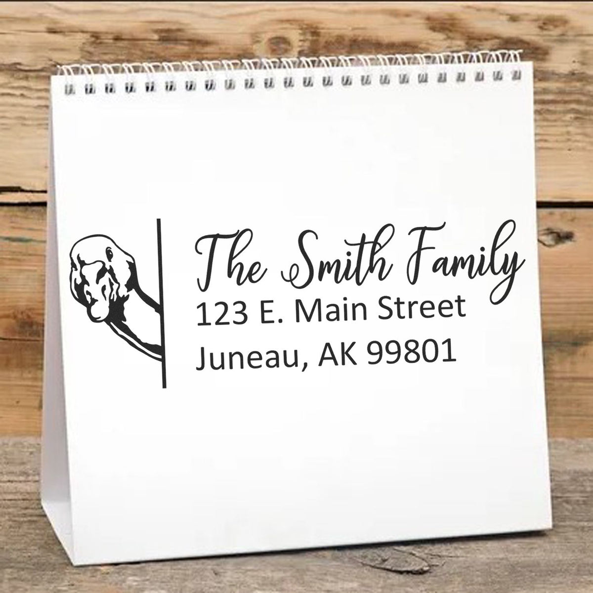 Custom return address rubber stamp with dog silhouette for The Smith Family, Juneau AK 99801.
