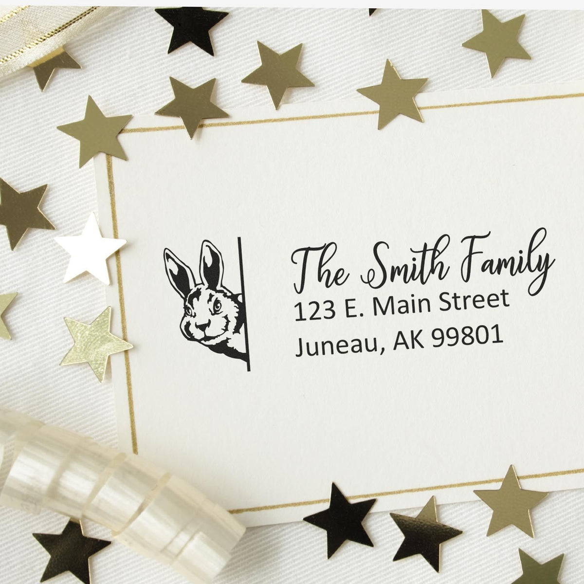 Custom rabbit return address rubber stamp with family name and mailing address for personalized envelopes.