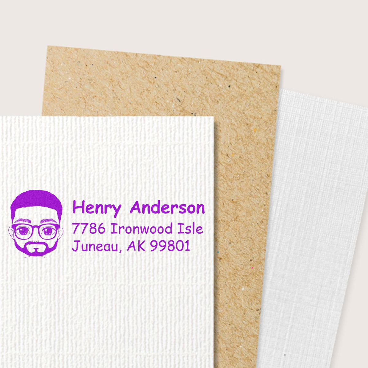 Custom address rubber stamp with purple portrait logo, name, and mailing address for personalized envelopes and packaging.