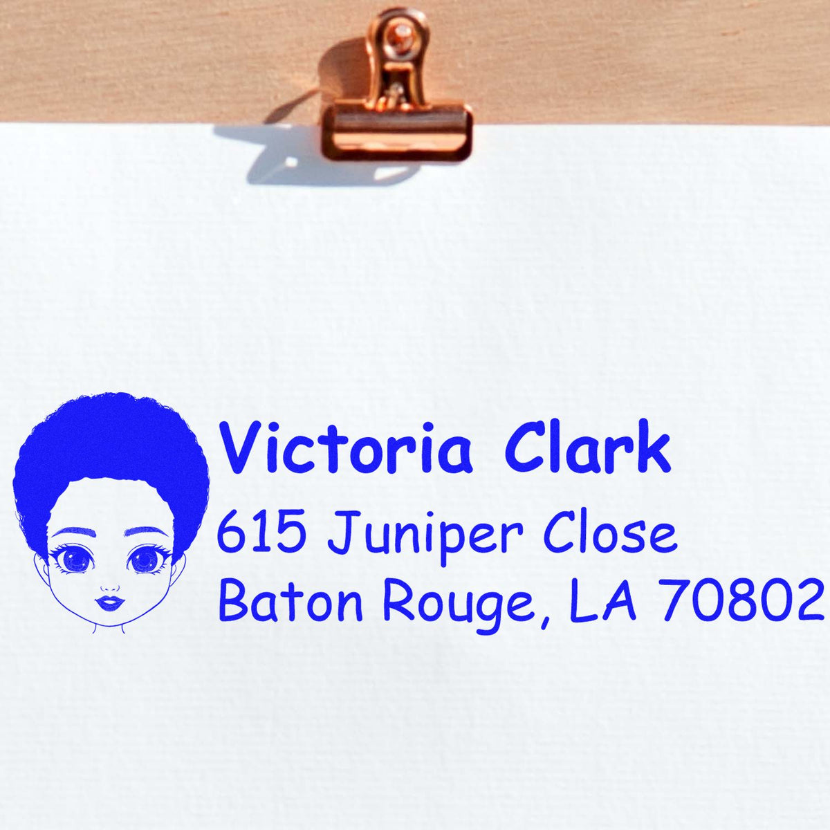 Custom return address rubber stamp with name Victoria Clark and Baton Rouge, LA address in blue ink.