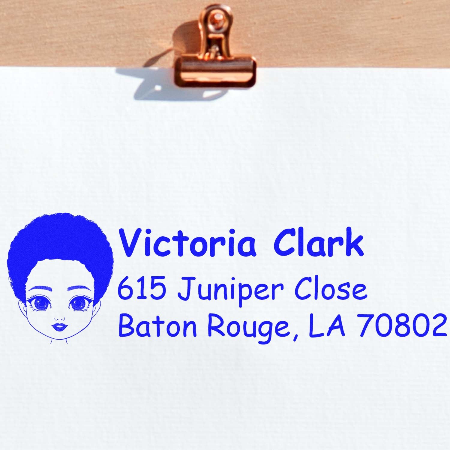 Custom return address rubber stamp with name, address and portrait icon for personal mail and package labeling.