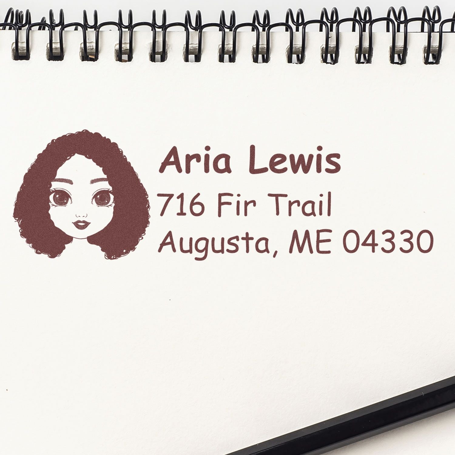 Personalized rubber address stamp with portrait icon, name, and mailing address for envelopes.