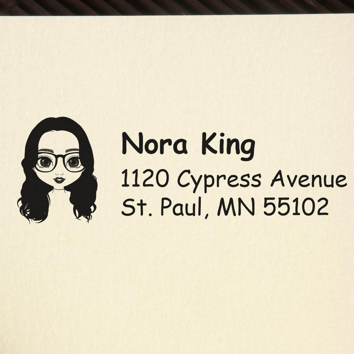 Personalized rubber address stamp with cartoon woman icon, Nora King, 1120 Cypress Avenue, St. Paul, MN 55102.