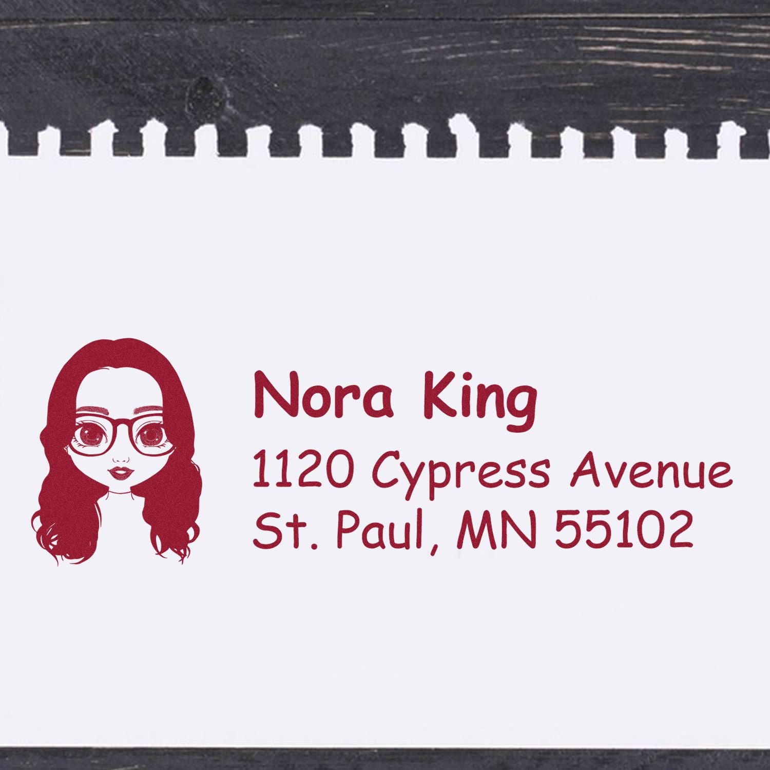 Personalized address rubber stamp with cartoon woman logo for Nora King, 1120 Cypress Avenue, St. Paul, MN 55102.