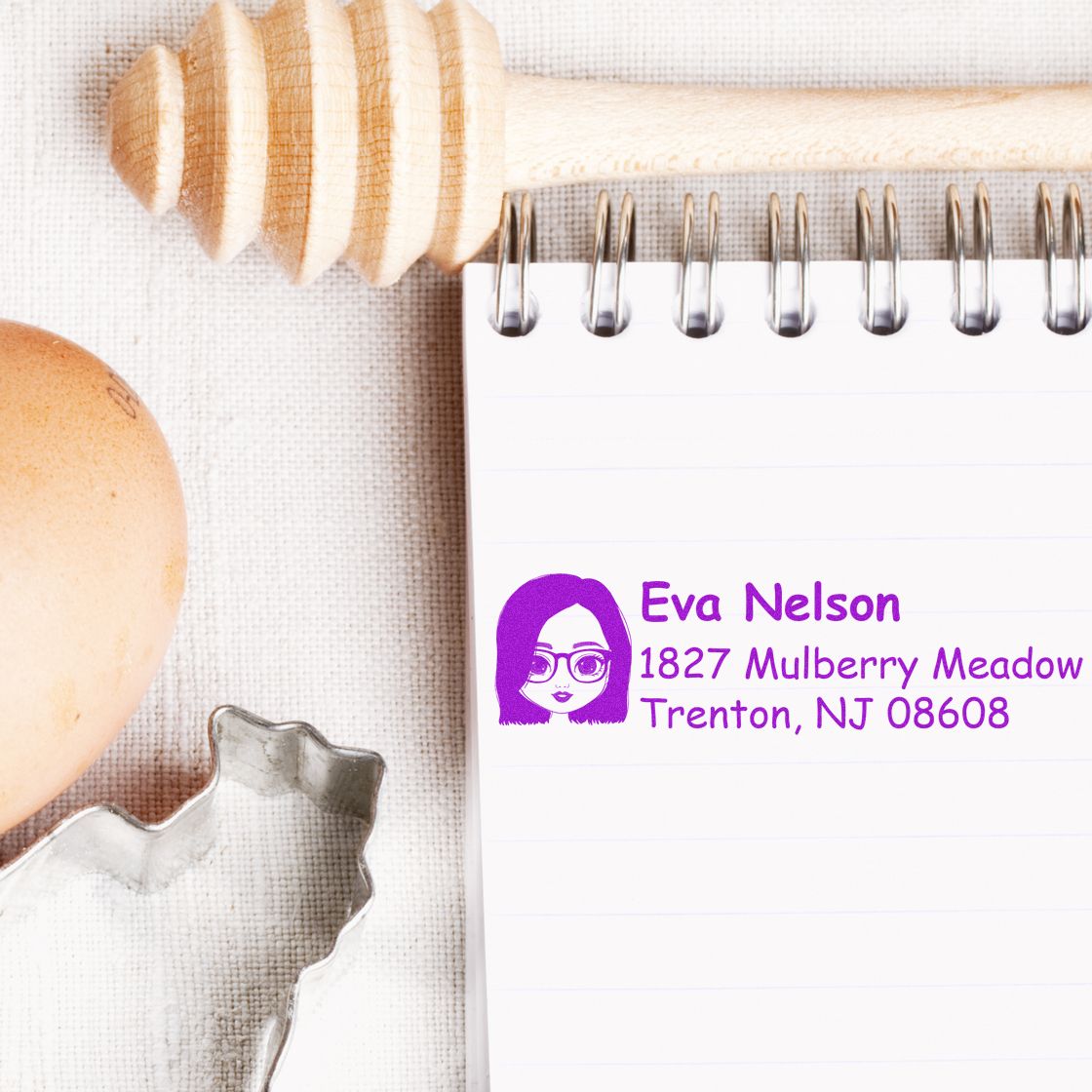 Custom address rubber stamp impression with name and address on a notepad, ideal for personalized stationery.