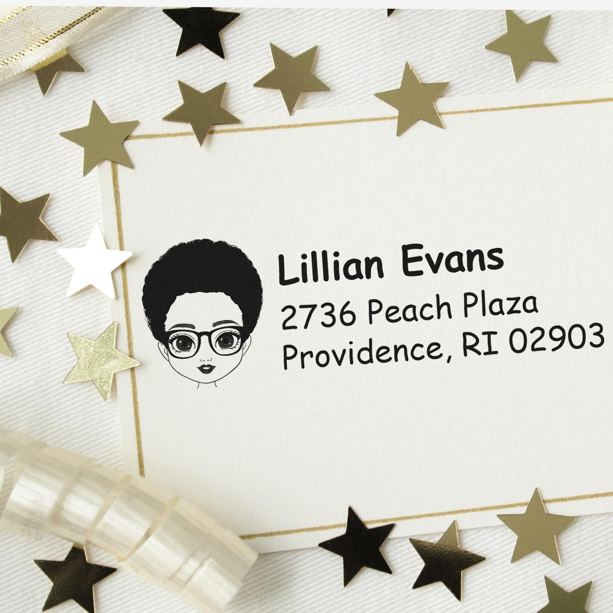 Personalized rubber address stamp with illustrated portrait, name, and mailing address on envelope.