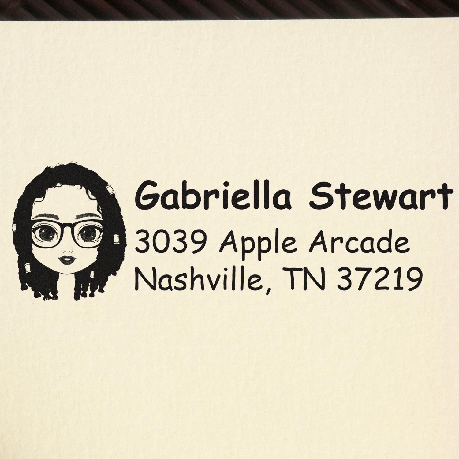 Custom rubber return address stamp with avatar illustration, Gabriella Stewart, 3039 Apple Arcade, Nashville, TN 37219.