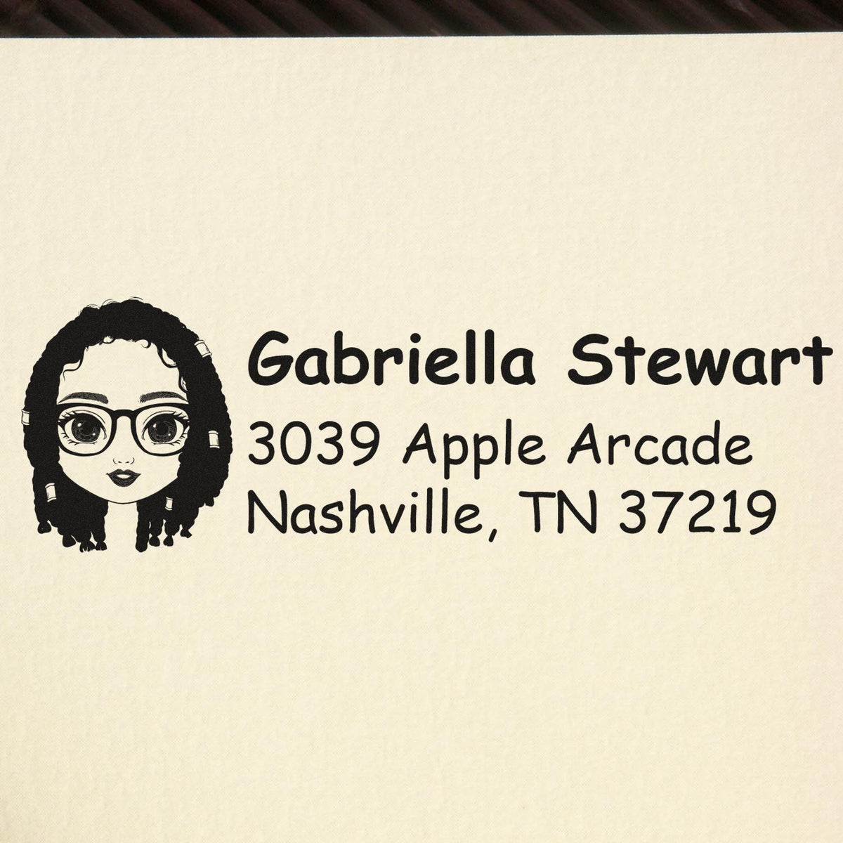 Custom return address rubber stamp for Gabriella Stewart, Nashville, TN 37219, with illustrated avatar.