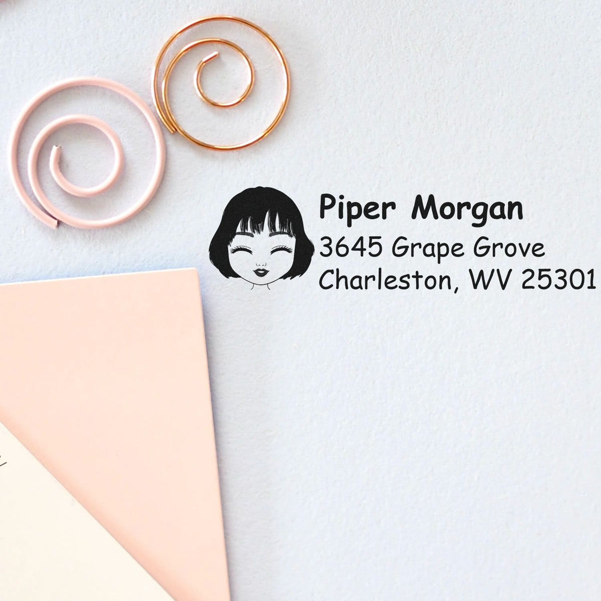 Custom rubber return address stamp with name, address, and girl icon for personalized stationery and envelopes.