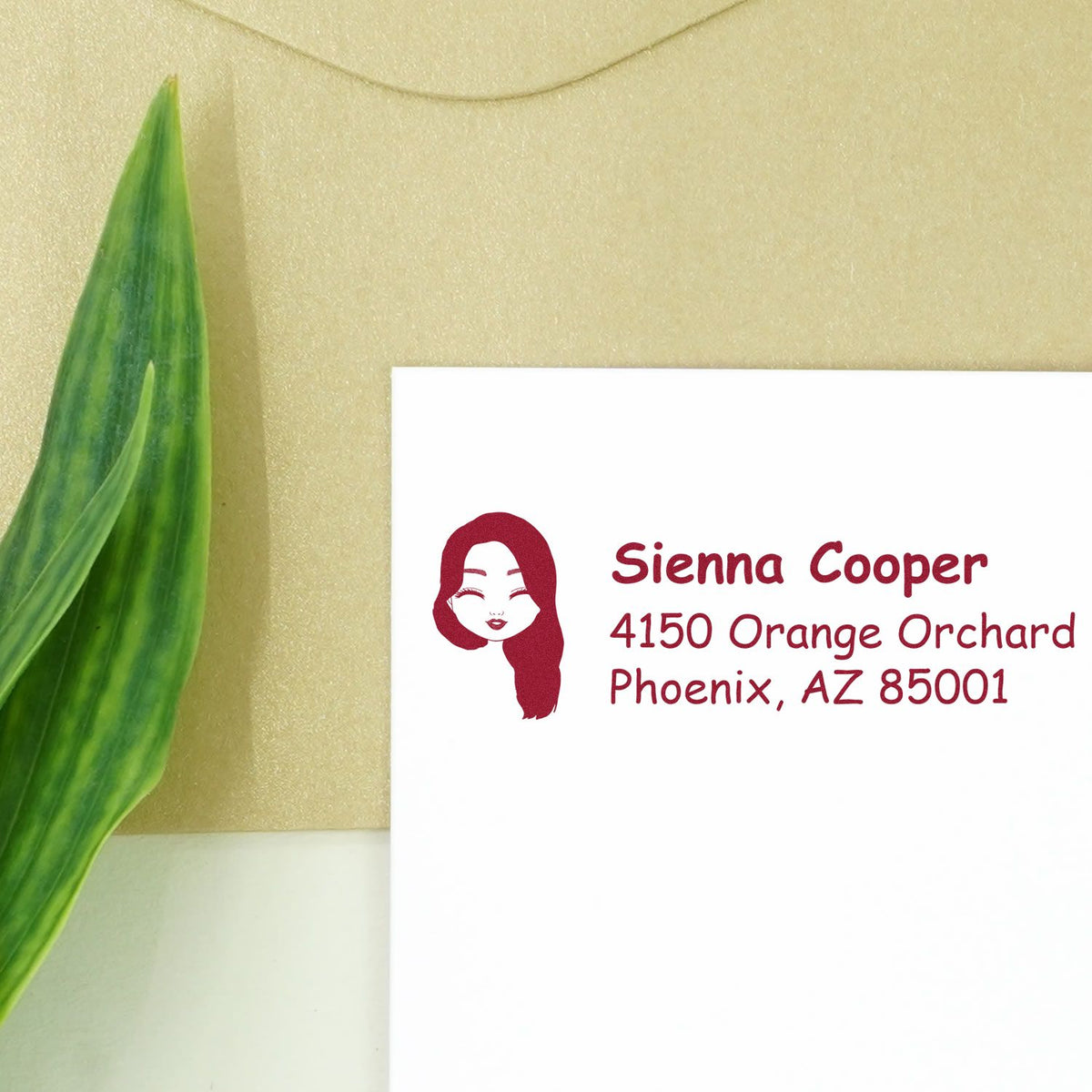 Custom return address rubber stamp with female icon, personalized Sienna Cooper Phoenix, AZ address on white envelope.