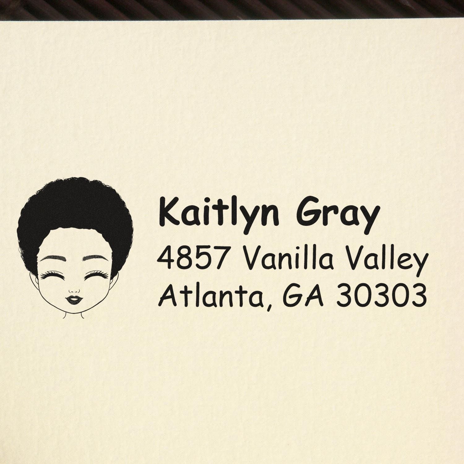 Custom rubber address stamp for Kaitlyn Gray with Atlanta, GA return address and face logo