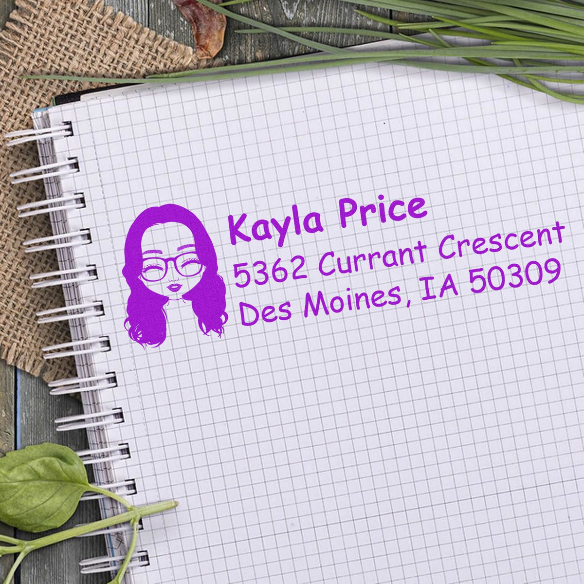 Purple return address rubber stamp with name, avatar, and Des Moines, IA mailing address on notebook paper.