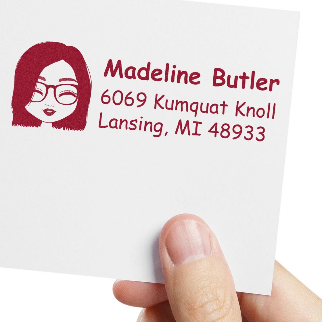 Custom return address rubber stamp with female avatar icon, name, and Lansing, MI address on a white card.
