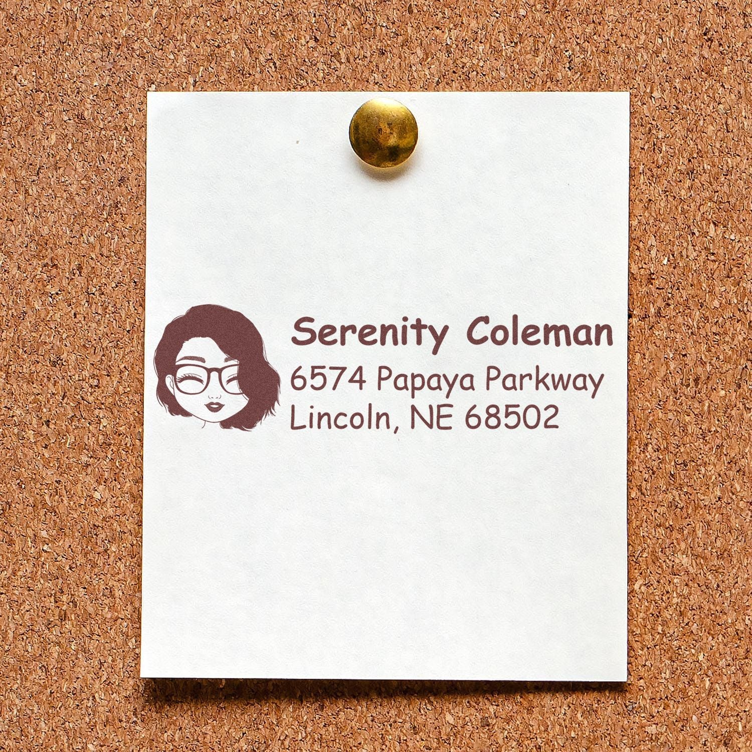 Custom return address rubber stamp imprint with name, address and avatar on a note pinned to corkboard.