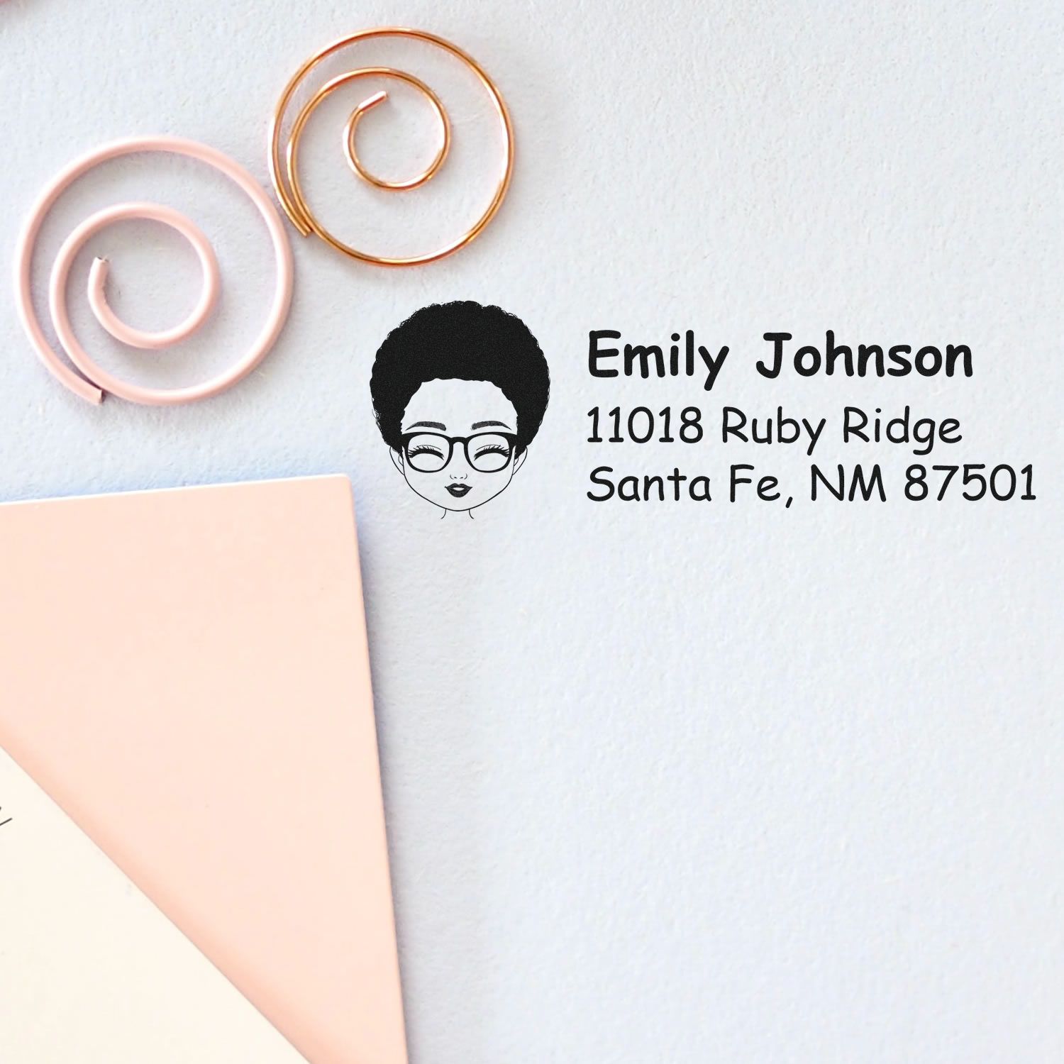 Custom return address rubber stamp with name, address and avatar logo on stationery envelope.