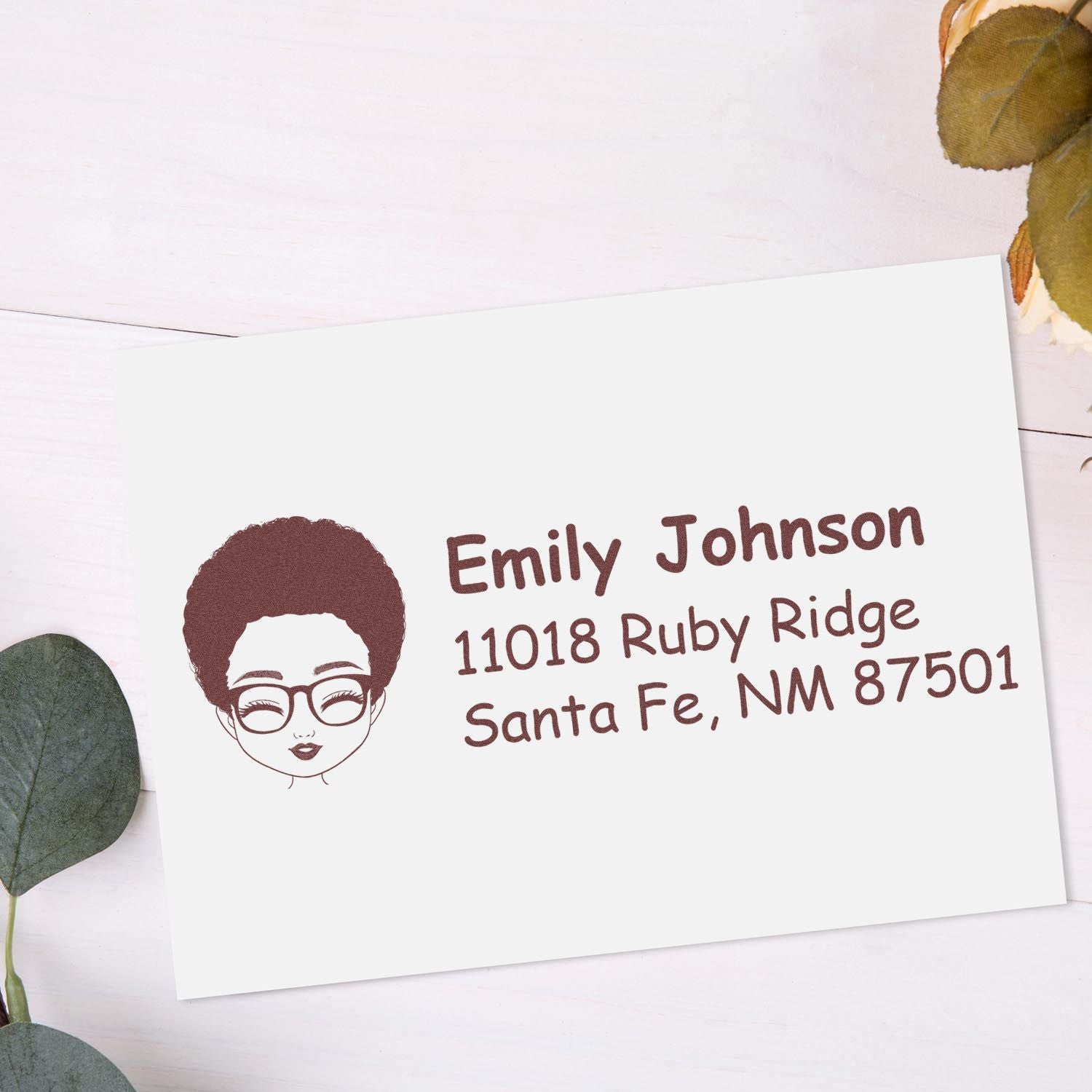 Personalized return address rubber stamp featuring name, address, and illustrated face logo