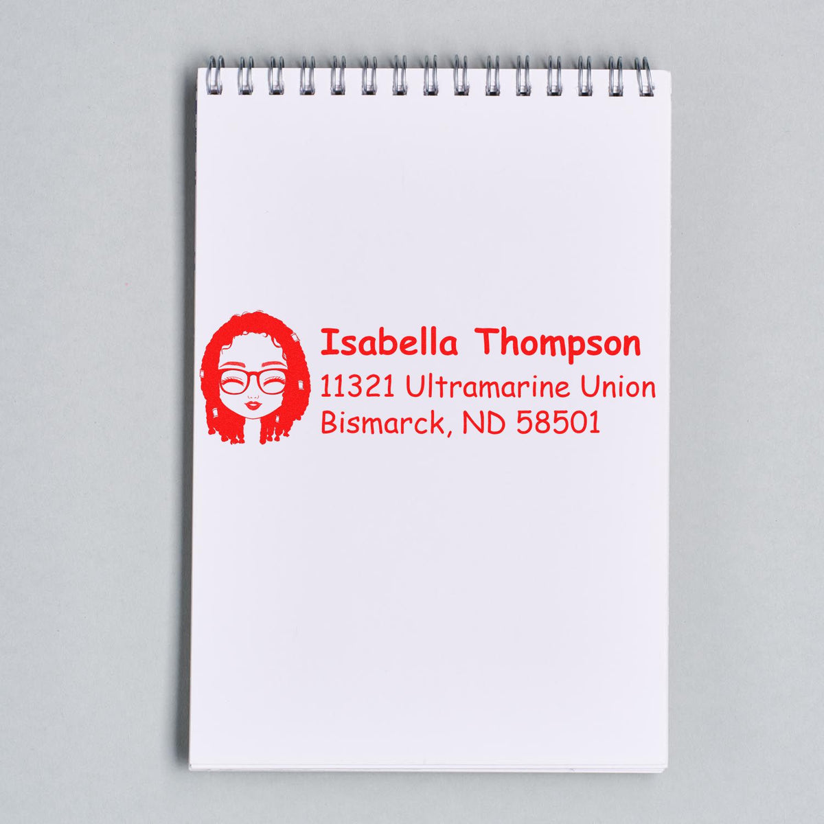 Personalized return address rubber stamp for Isabella Thompson with custom Bismarck, ND address in red.
