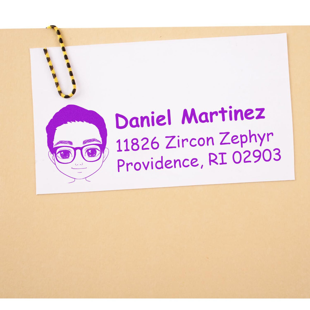 Custom return address rubber stamp with cartoon avatar, Daniel Martinez, 11826 Zircon Zephyr, Providence, RI 02903.
