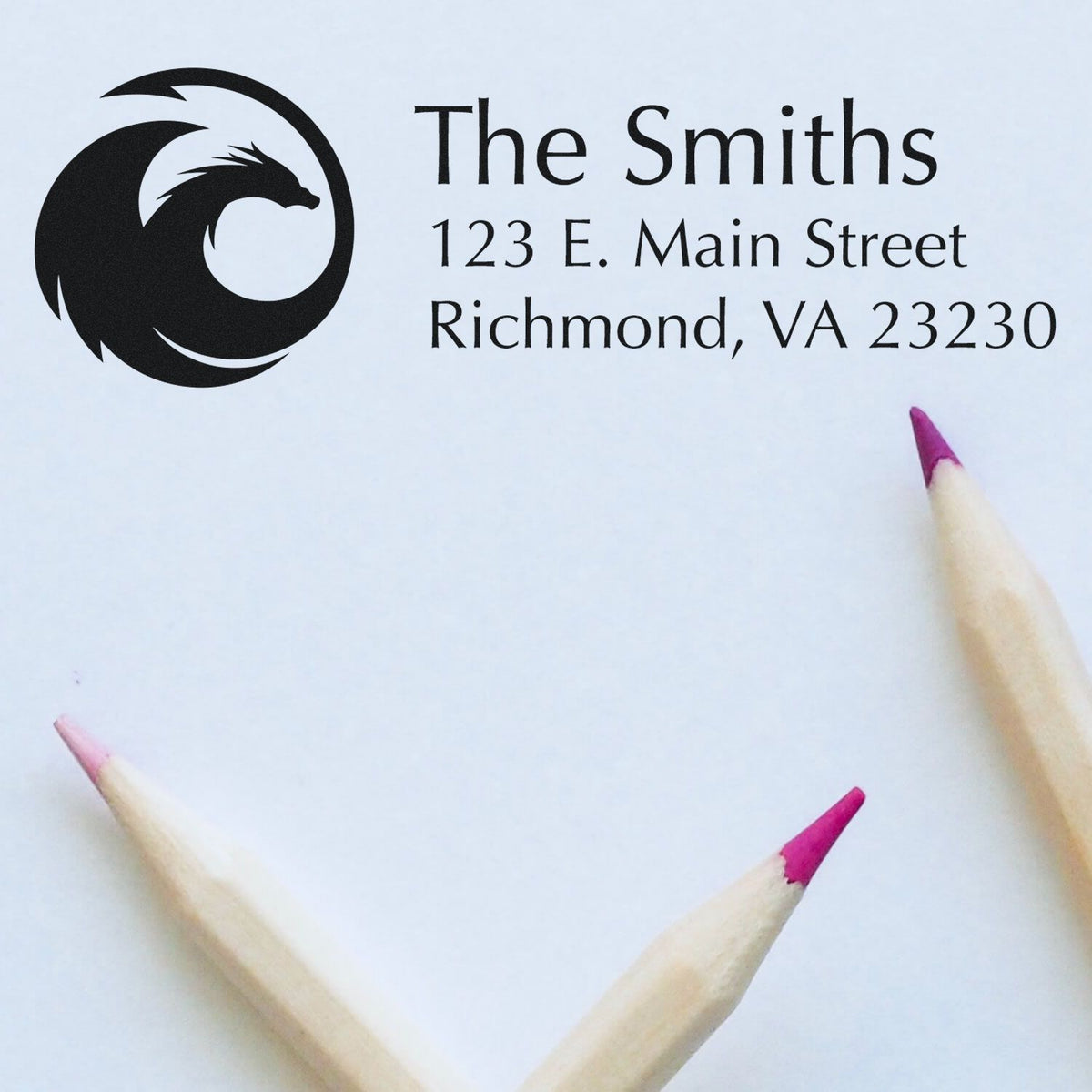 Personalized rubber return address stamp for The Smiths with dragon logo, Richmond, VA 23230, shown on paper.