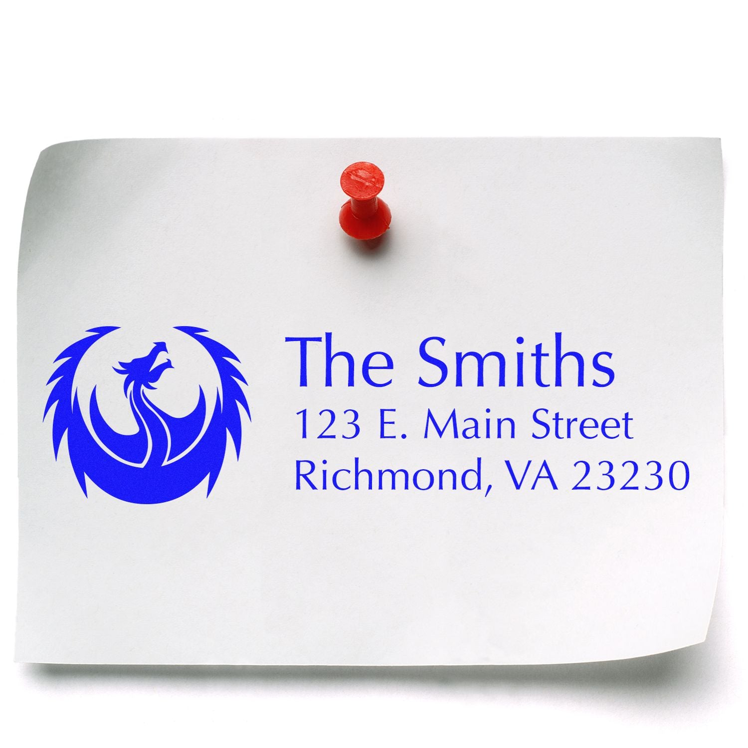 Custom rubber stamp impression with phoenix logo and address for The Smiths, Richmond, VA on white paper with red pushpin.