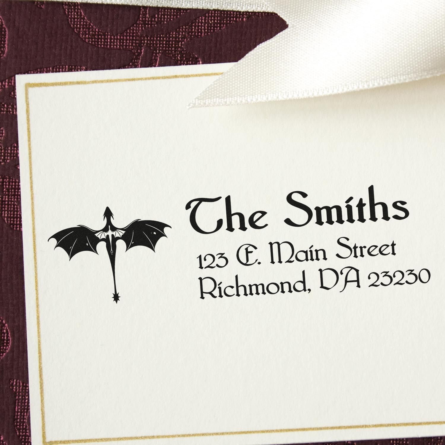 Custom rubber return address stamp with bat icon for The Smiths, 123 E. Main Street, Richmond, DA 23230.