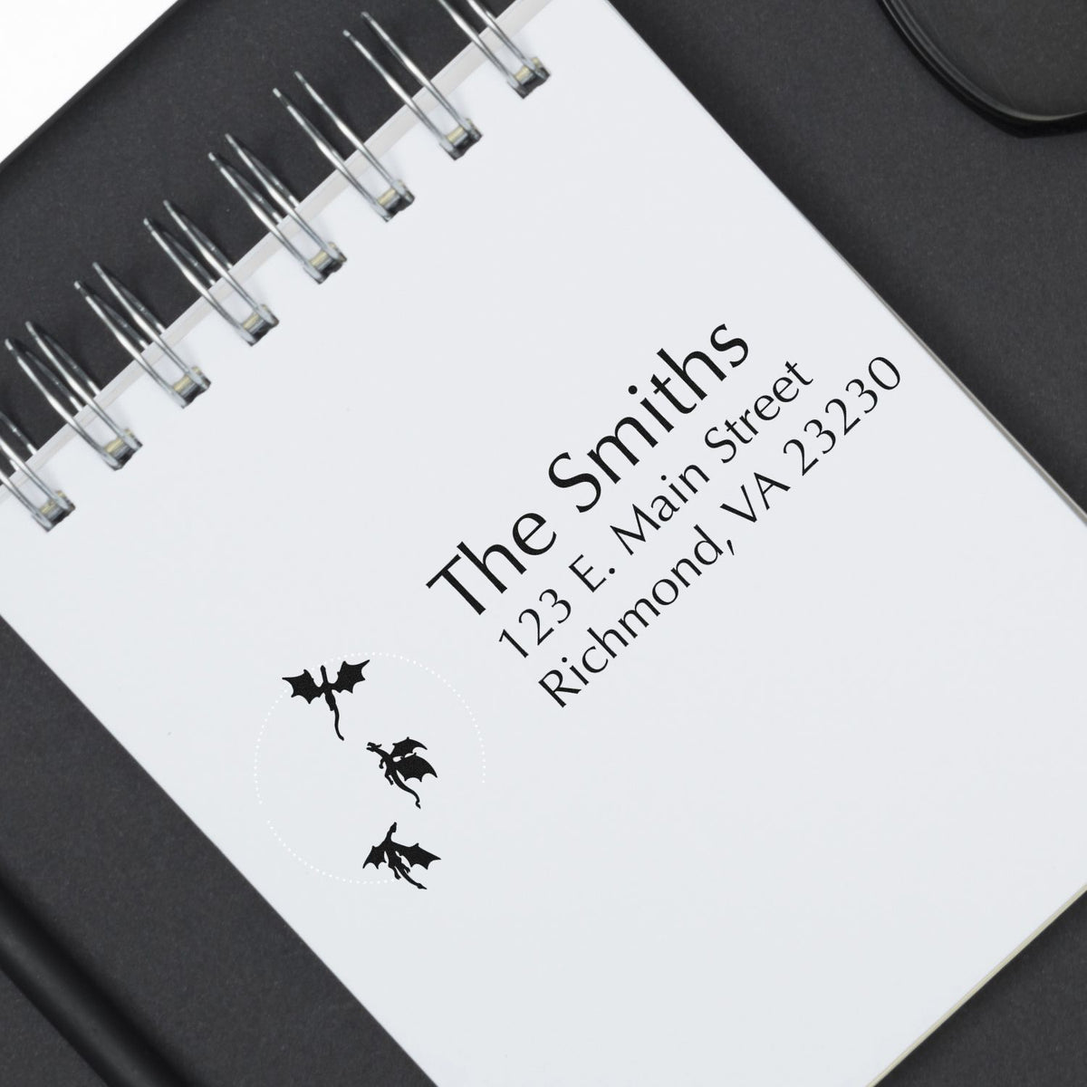 Custom return address rubber stamp on spiral notebook with Halloween bat design and The Smiths mailing address.