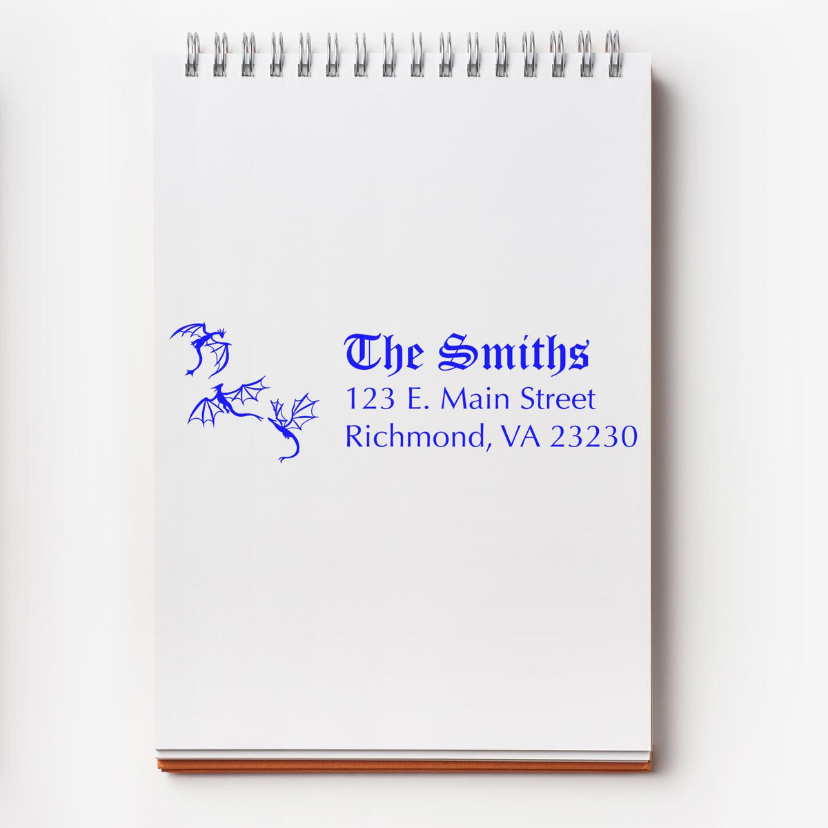 Custom return address rubber stamp on notepad, featuring The Smiths, Richmond VA address, and dragon artwork for personalized mailings.