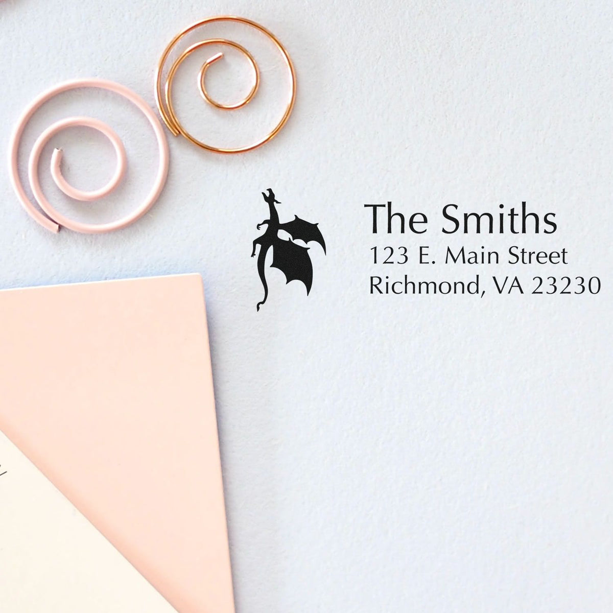 Custom rubber stamp with dragon logo return address for The Smiths, Richmond, VA 23230 on stationery.