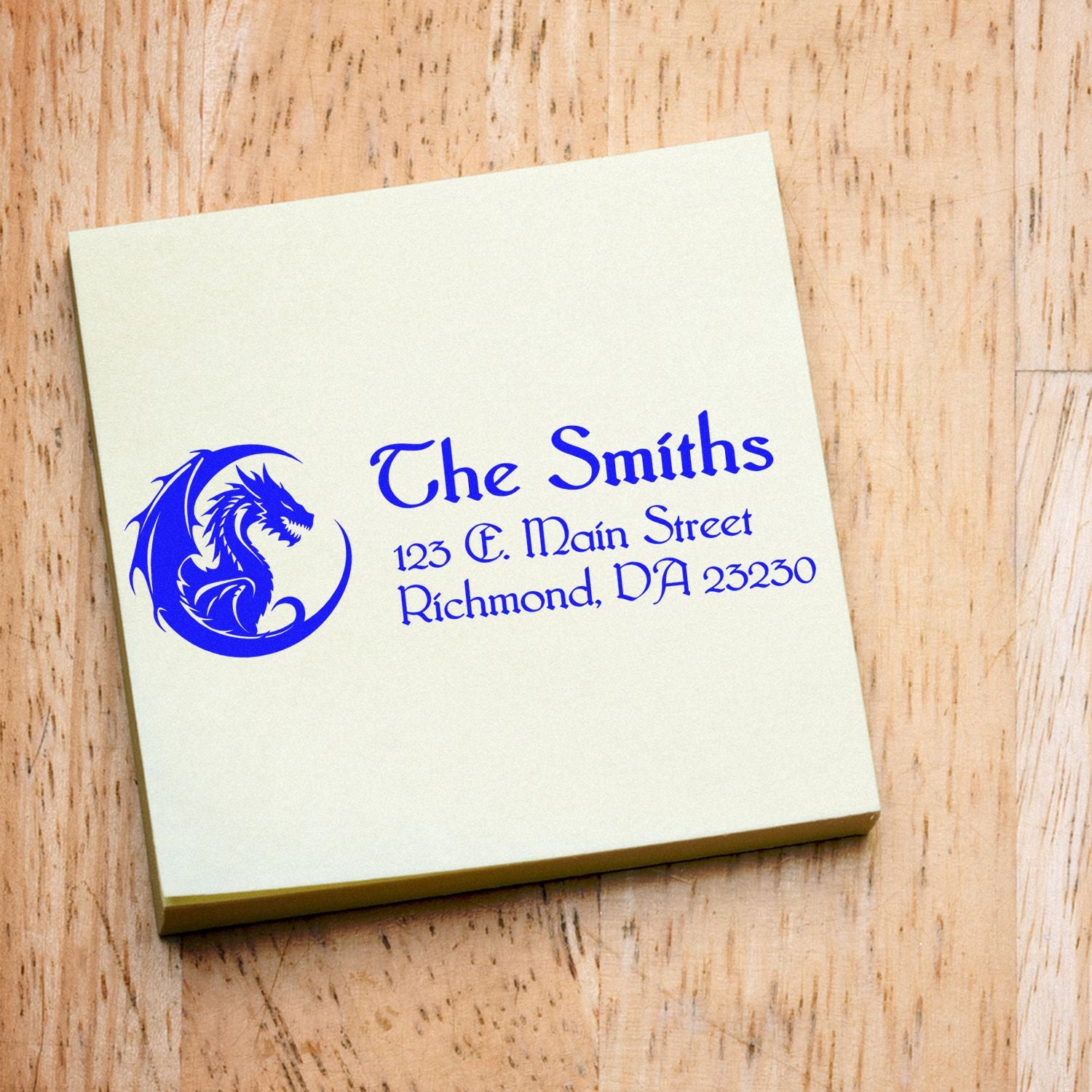 Custom rubber address stamp featuring a dragon logo, The Smiths name, and Richmond address for personalized stationery and mail.