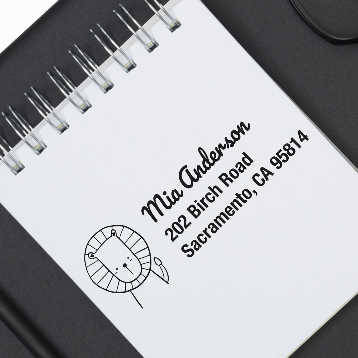 Personalized return address rubber stamp with lion logo, name, and Sacramento address for stationery
