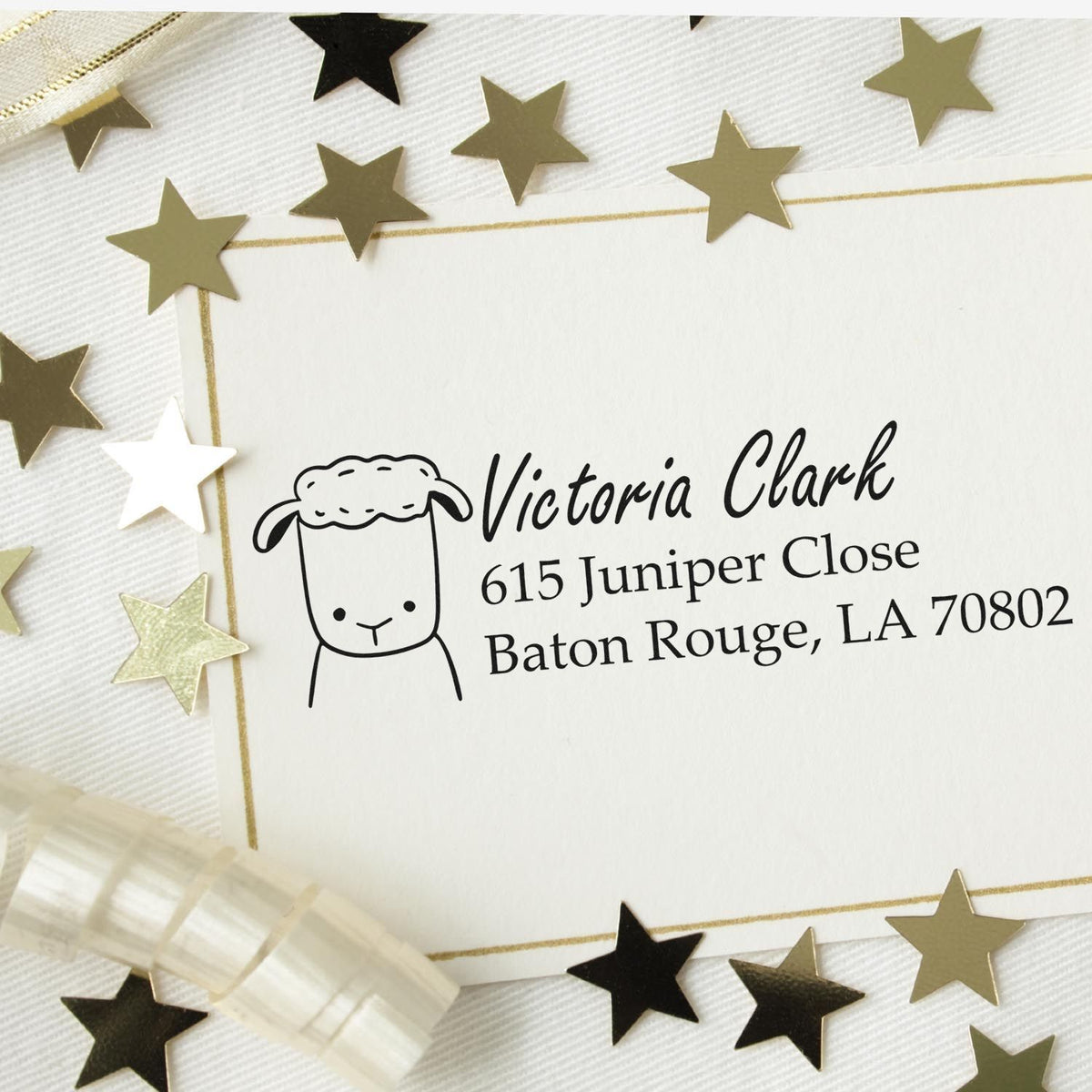 Custom return address rubber stamp with cute sheep icon on envelope, personalized for Victoria Clark.