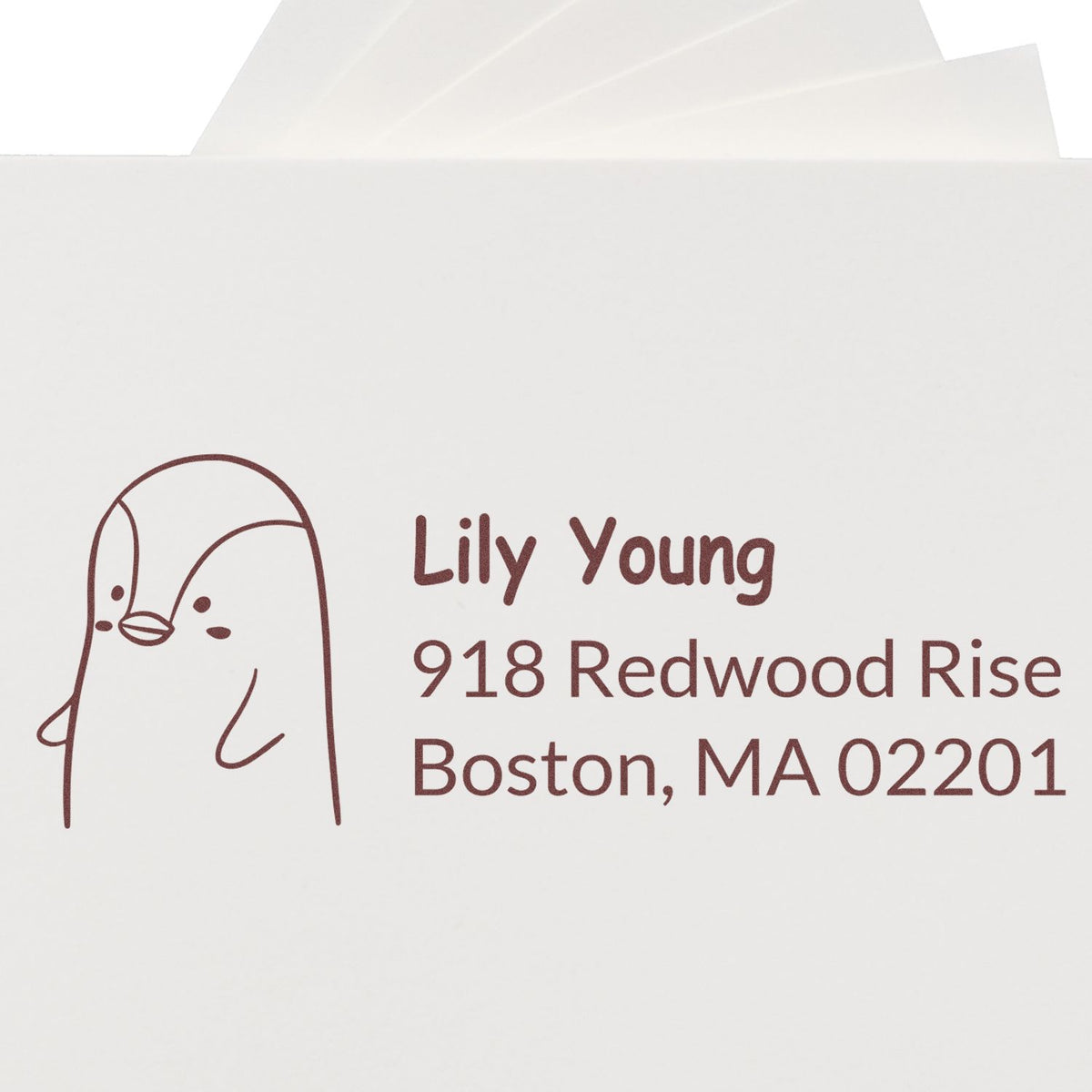 Personalized return address rubber stamp with penguin illustration for Lily Young, Boston MA envelope labeling.