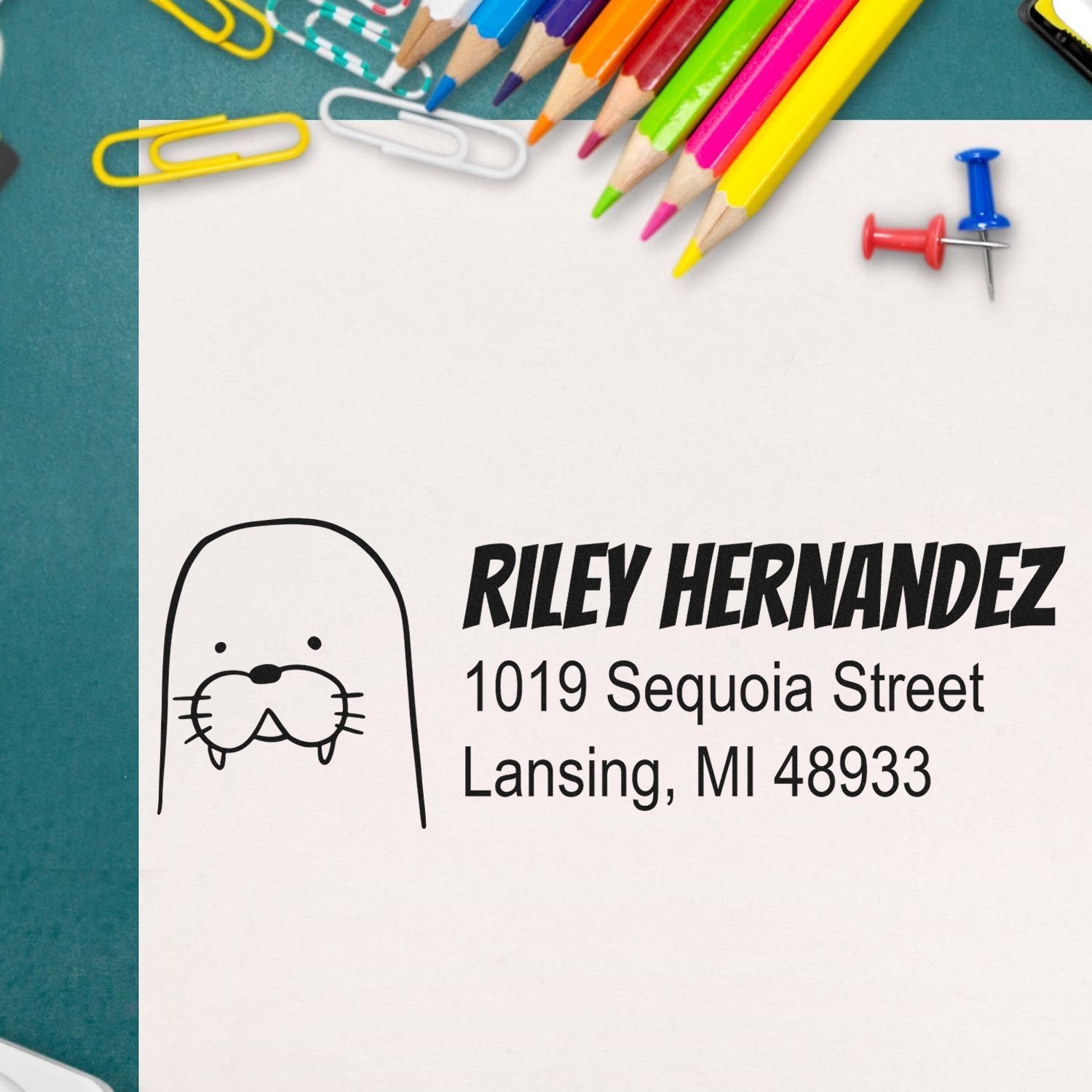 Custom rubber return address stamp with dog icon, featuring Riley Hernandez and Lansing, MI for mailing and packaging.