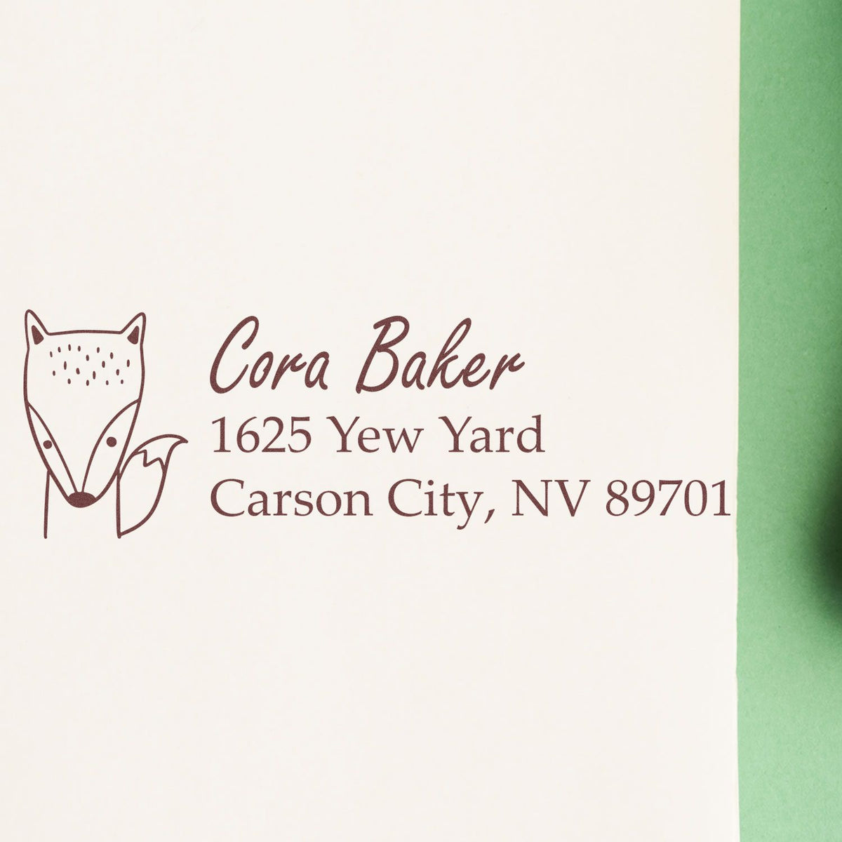 Personalized rubber return address stamp with fox logo for Cora Baker, Carson City, NV.