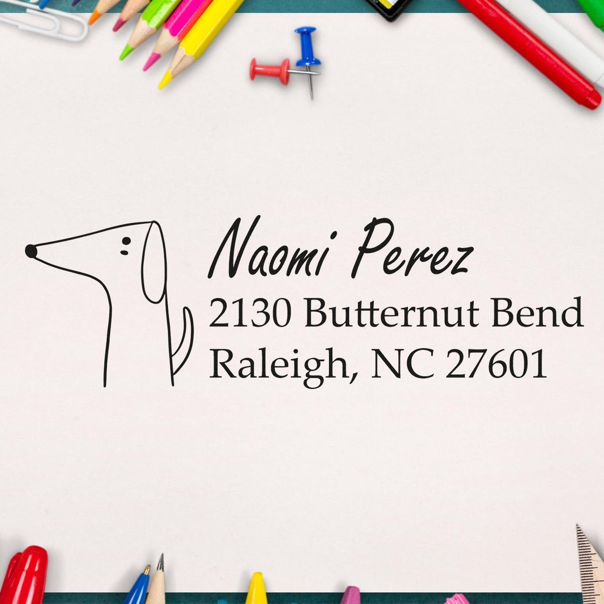 Custom rubber address stamp with dog logo, name, and Raleigh NC return address for personalized mailing use