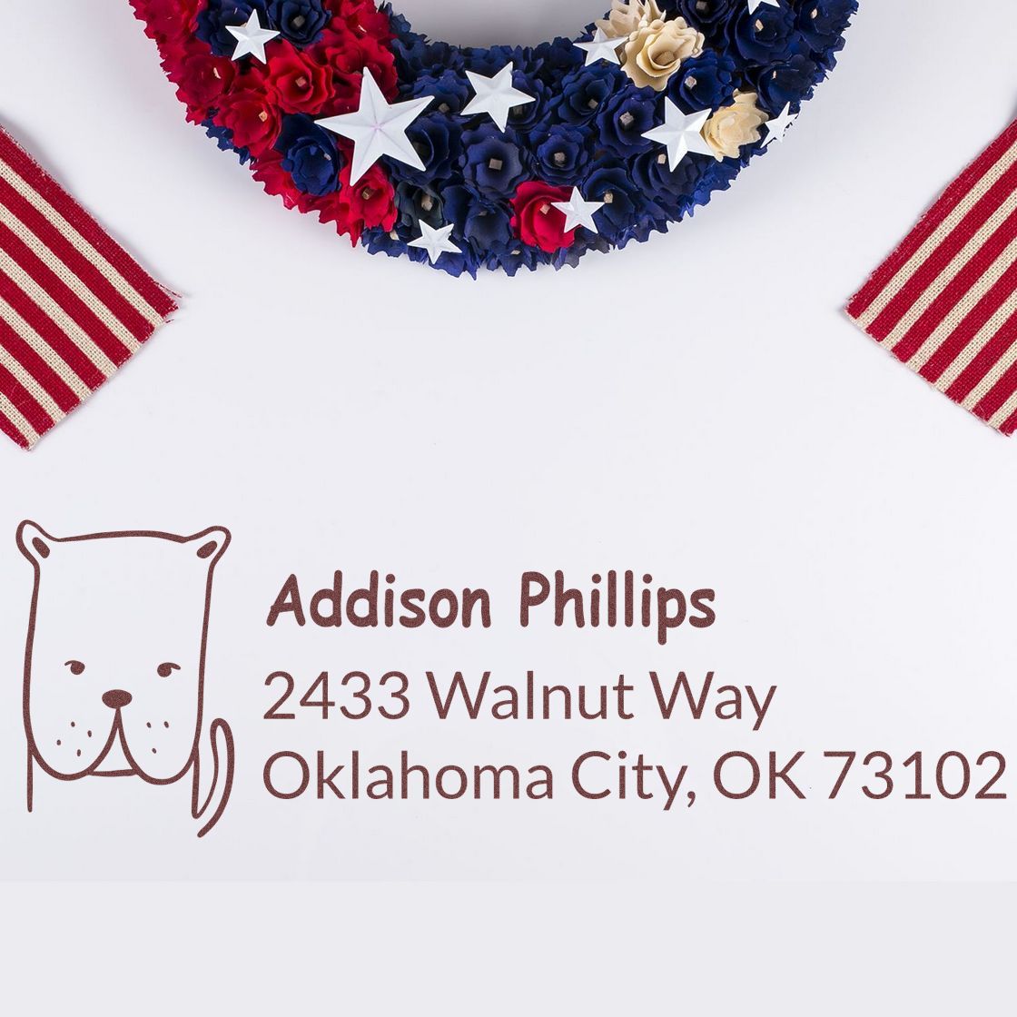 Custom rubber address stamp with bear icon and Addison Phillips address beneath patriotic red, white and blue decor